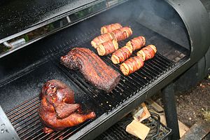 Some chicken, pork and corn in the barbeque